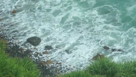 See the waves on the beach from the cliff Stock Footage 295472481