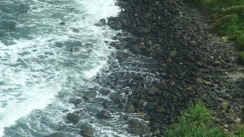 See the waves on the beach from the cliff Stock Footage 295472490