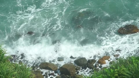 See the waves on the beach from the cliff Stock Footage 295472493