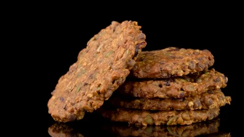 Seed and Chocolate Chip Cookie Stack Reveal Shot on Dark Background Stock Footage 330514642