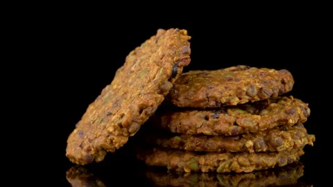 Seed and Chocolate Chip Cookie Stack Rotating Under Studio Lighting Stock Footage 330517499