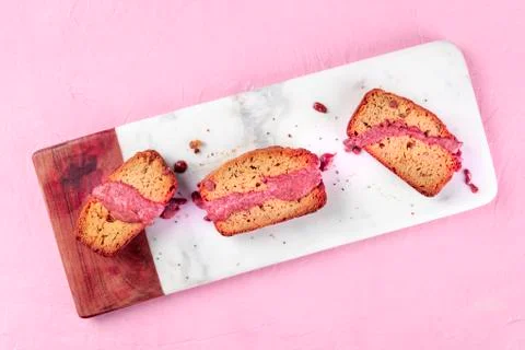 A seed cake with ruby chocolate, shot from the top on a pink background with a Foto stock