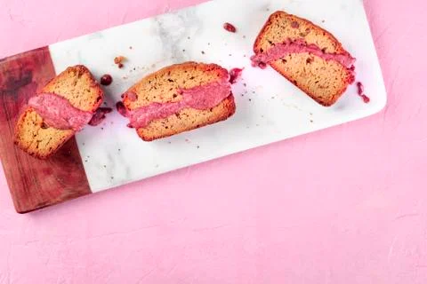 A seed cake with ruby chocolate, shot from above on a pink background with 写真素材