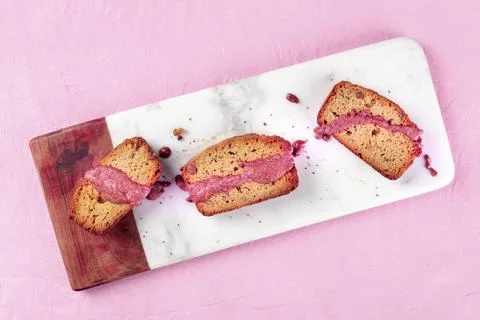 A seed cake with ruby chocolate, shot from the top on a pink background with a Stock Photos