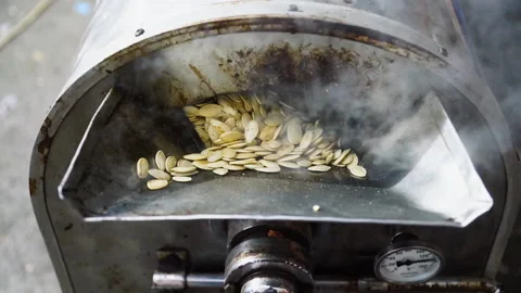 The seed roaster roasts pumpkin seeds. Stock Footage 142123757