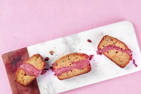 A seedcake with ruby chocolate, shot from the top on a pink background with a Stock Photos