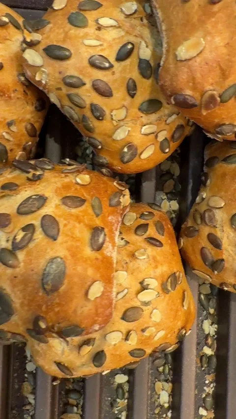 Seeded bread rolls with pumpkin seeds in bakery tray Video stock 317321465