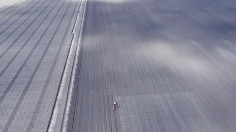 Seeding the Crop Fields with a Tractor Stock Footage 254436186