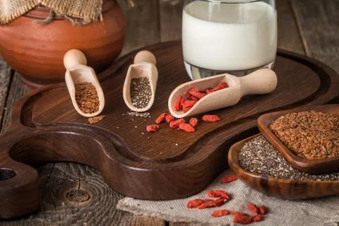 Seeds and goji in a wooden spoons Stock Photos