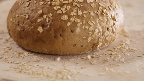 The seeds fall on the fresh bread in the oven Video stock 143980390