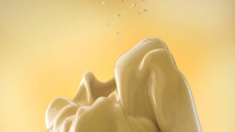 Seeds sprinkle on a yellow mango fruit jelly on a yellow background Stock Footage 114739021