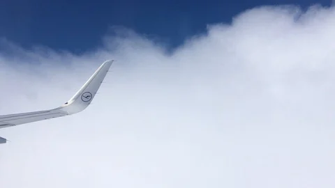Seeing an airplane wing flying out of clouds Stock Footage 104802489