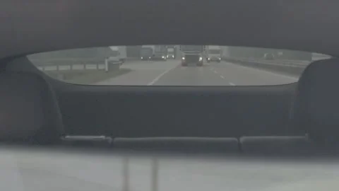 Seeing the flow of traffic on the highway in the rearview mirror. Stock Footage 344011194