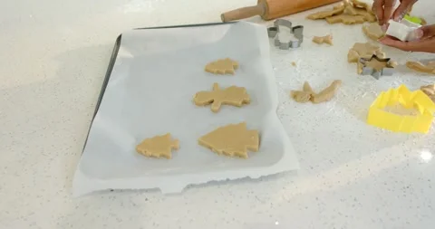 Seeing scraps, diverse couple cutting, arranging cookie shapes on tray on Stock Footage 340069086