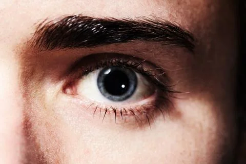 Seeing something he likes. Closeup portrait of an eye with dilated pupil. 库存照片