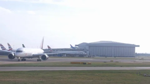 Seen from airplane window, various international airliners on tarmac at London's Stock Footage 103157813