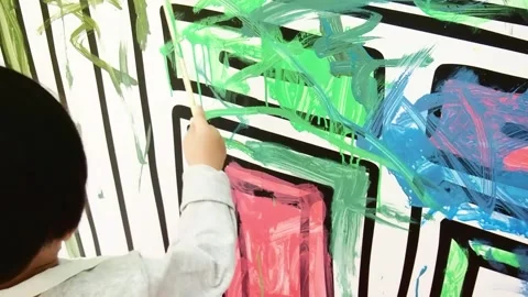 Seen from behind, the child is coloring the wall Stock Footage 270278356
