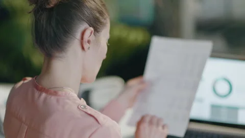 Seen from behind modern female with documents having headache Stock Footage 252758251
