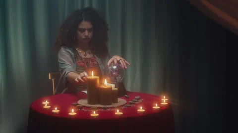 Seer Lighting Candle and Touching Crystal Ball during Clairvoyance Session Stock Footage 253180480