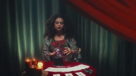 Seer Using Crystal Ball while Sitting at Desk with Tarot Layout Stock Footage 253178678