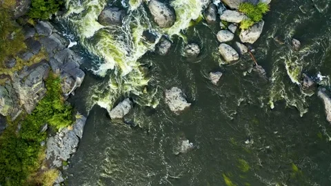 Seething rapids of a mountain river with a rocky shore . top view from the drone Video stock 133185537