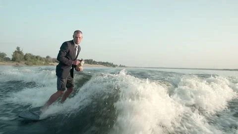 Sefer eats chips and rides a wakeboard. Video stock 160399838