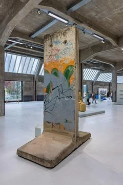 A segment of the Berlin Wall on display inside the Fenix Museum, with colorfu Stock Photos