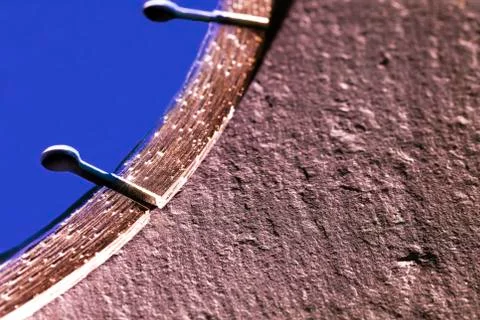Segment of a diamond cutting disc on a background of gray concrete. Stock Photos