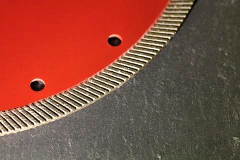 Segment of a diamond cutting disc on a background of gray concrete. Stock Photos