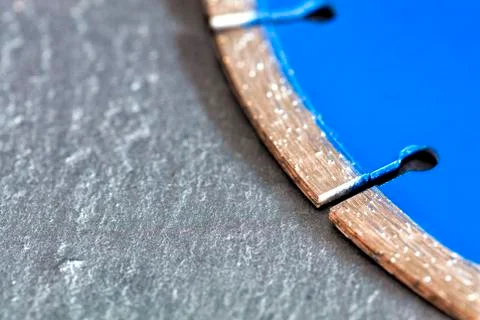 Segment of a diamond cutting disc on a background of gray concrete with a pla Stock Photos