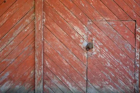Segment of red garage doors with diagonal boards.	 Stock Photos