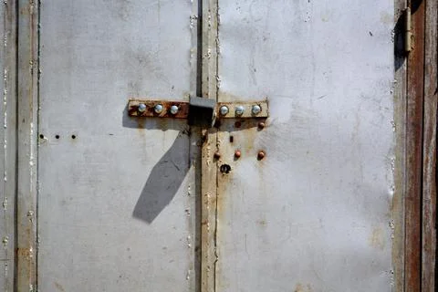 Segment of red garage doors with diagonal boards.	 Stock Photos
