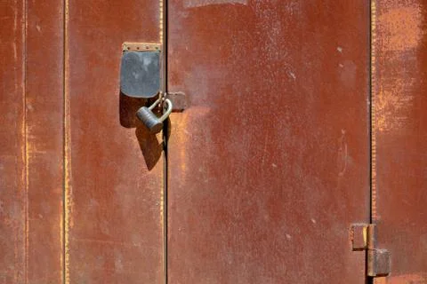 Segment of rusty garage doors with two locks.	 Stock Photos