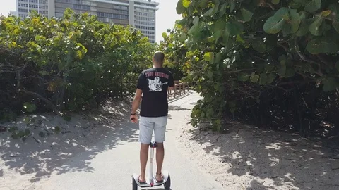 Segway Smart Self-Balancing man woman riding in the park on electric scooter Stock Footage 74062397