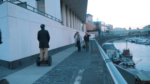 Segways Passing By A Couple Stock Footage 96241172