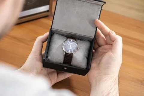 Seiko watch inside a gift box held by a man to show premium quality and luxury Stock Photos