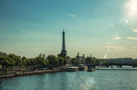 Seine River with bridge and the Eiffel Tower at sunset in Paris Stock Photos
