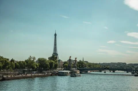 Seine River with bridge and the Eiffel Tower at sunset in Paris Stock Photos