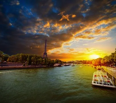 Seine river with Eiffel tower on the background at sunset Stock Photos