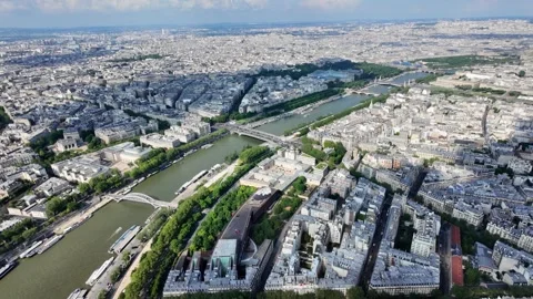 Seine river flowing through the expansive cityscape of paris, france Видео 328023221