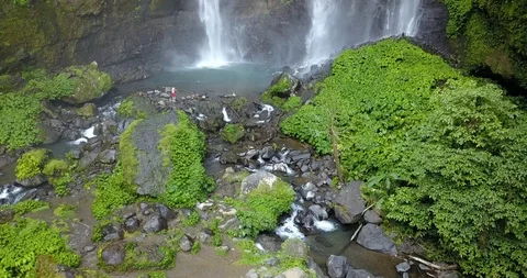 Sekumpul Waterfall in Bali with a men, Indonesia. Drone aerial Shot Stock Footage