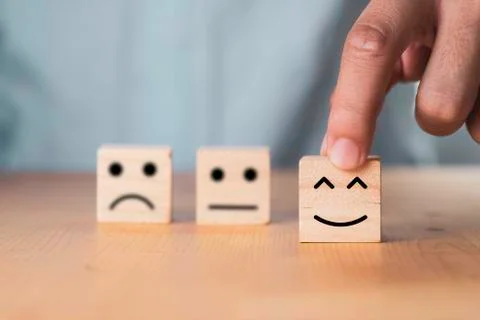 Select emotion or mood concept , Hand holding smile face  or happy face Stock Photos