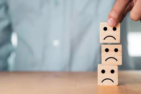 Select emotion or mood concept , Hand holding and stacking sad  face Stock Photos