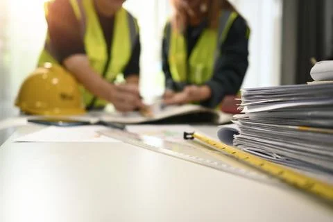 Select focus on blueprints and technical tools on white table with architects Stock Photos
