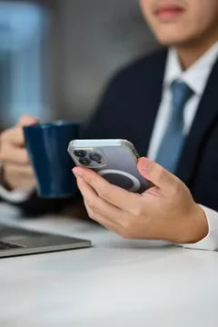 Select focus on businessman using smartphone texting messages, chatting in Stock Photos