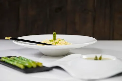 Select focus of a delicious looking plate of pasta and asparagus with out of  Stock Photos