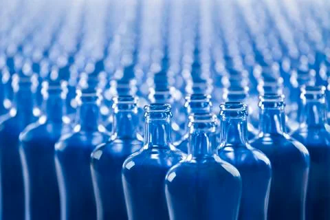 Select focus of empty blue glass bottles. Glass and abstract concept. Stock Photos