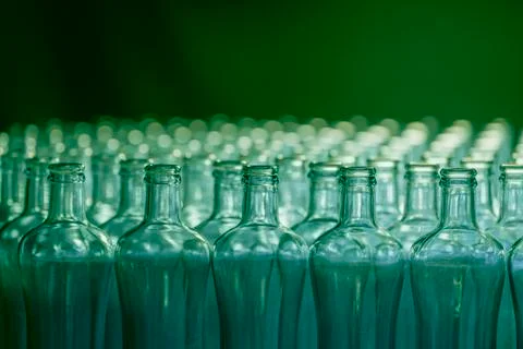 Select focus of green empty glass bottles on an out of focus background. Glas Stock Photos