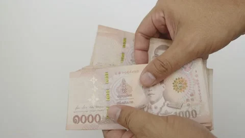 Select focus of hands counting a lot of thousands Thai baht banknotes money. Stock Footage 237509461