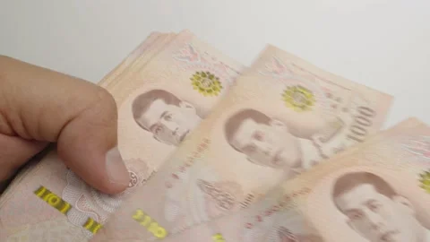Select focus of hands counting a lot of thousands Thai baht banknotes money. Stock Footage 237509467